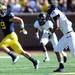 Michigan wide receiver Drew Dileo runs the ball past UMass safety Darren Thellen in the second quarter at Michigan Stadium on Saturday. Melanie Maxwell I AnnArbor.com